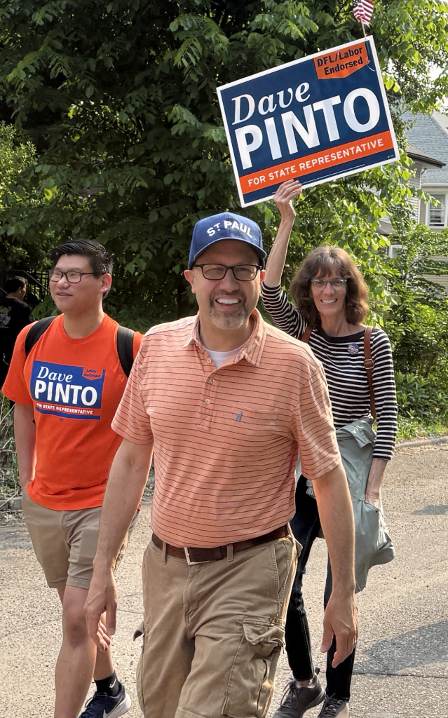 Representative Dave Pinto walking in parade with other participants
